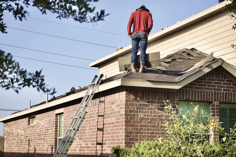 Professional roofer working on a residential roof in Passaic
